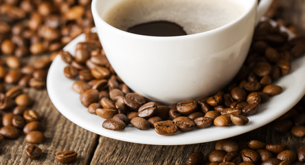 hot coffee and coffee beans on the background of coffee grinders