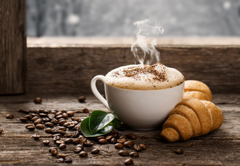 Hot coffee and pastries on a wooden background - obrazy, fototapety, plakaty
