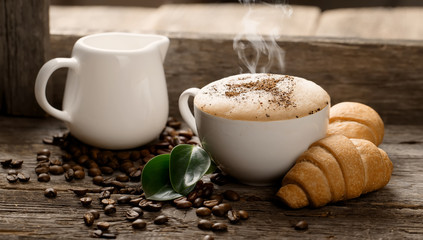 Hot coffee and pastries on a wooden background