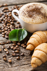 Hot coffee and pastries on a wooden background