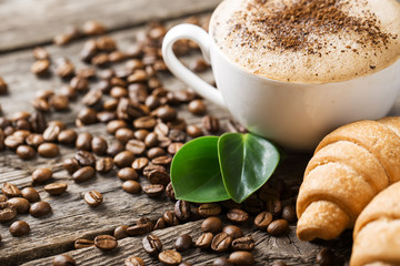 Hot coffee and pastries on a wooden background