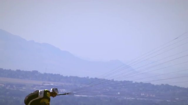 Man paragliding and rotating in the sky from Point of the mountain near Draper, UT.