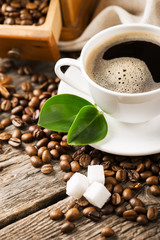 hot coffee and coffee beans on the background of coffee grinders