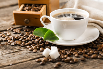 hot coffee and coffee beans on the background of coffee grinders