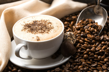 hot coffee and coffee beans on the background of coffee grinders