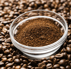 Natural ground coffee heap in transparent glass bowl on сoffee