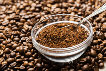 Natural ground coffee heap in transparent glass bowl on сoffee
