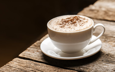 Close-up of coffee cup  on wooden background.