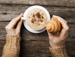 woman holding hot cup of coffee