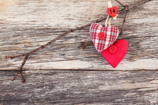 Two red hearts on wooden background. Toned, copy space.