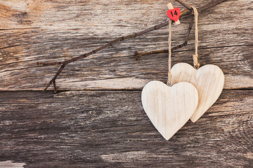 Two wooden hearts on wooden  background. Copy space, soft focus, toned, vintage style 