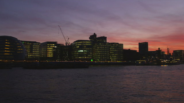Pan of London cityscape after sunset.