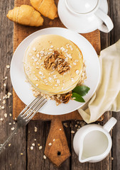 delicious pancakes on a wooden table with nuts