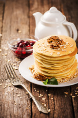 delicious pancakes on a wooden table with nuts