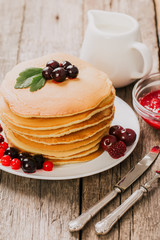 delicious pancakes on a wooden table with nuts