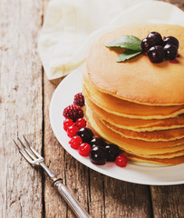 delicious pancakes on a wooden table with nuts