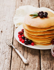 delicious pancakes on a wooden table with nuts
