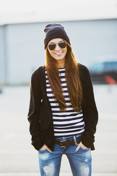 Outdoor fashion closeup portrait of nice pretty young hipster wo