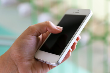 Woman holding smartphone indoors