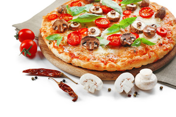 Tasty pizza and fresh vegetables on round wooden board, close up