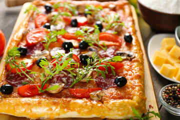 Rectangle delicious pizza and vegetables on the table