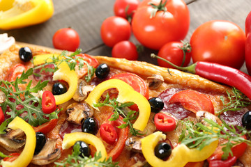 Rectangle delicious pizza and vegetables on the table, close-up