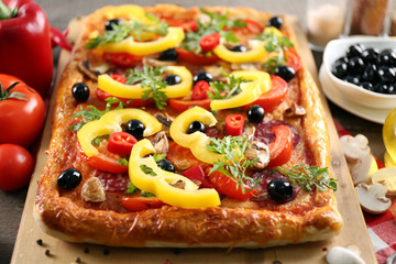 Rectangle delicious pizza and vegetables on the table