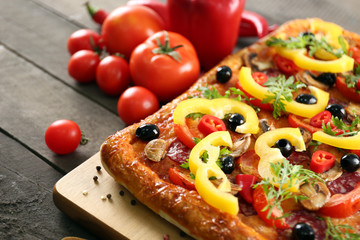 Rectangle delicious pizza and vegetables on the table