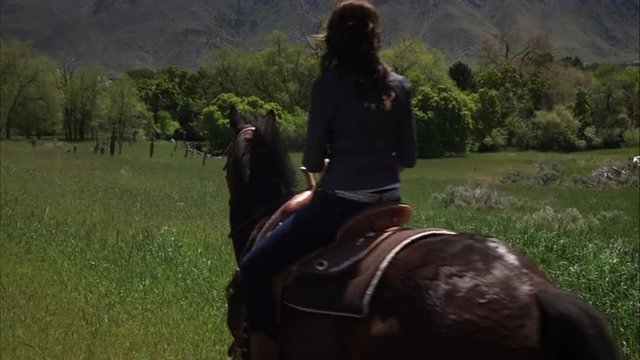 Slow motion shot of a woman on horseback.