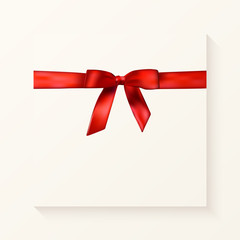 Holiday background with realistic shiny red satin gift bow and ribbon