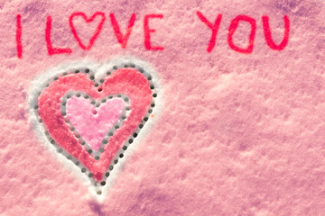 I love you with heart sign writing on the snow. 