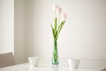 tulips on the table with coffee cup 