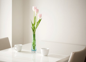 tulips on the table with coffee cup 