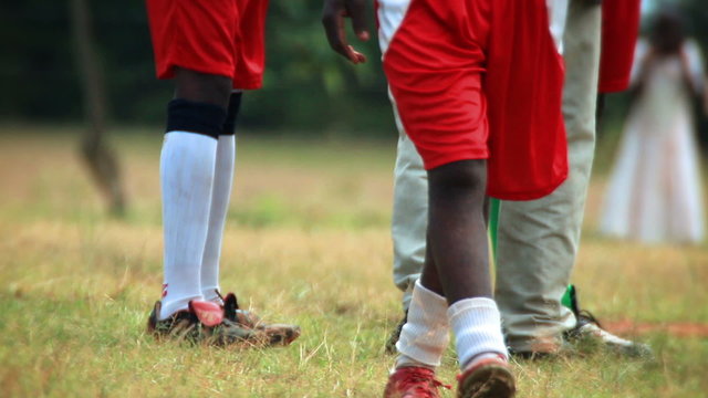 Close up of legs and feet of young football players