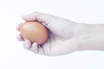 Hand holding egg isolated on white background