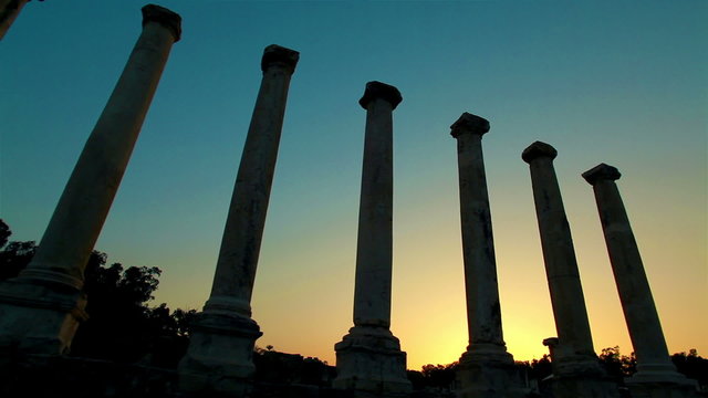 Stock Footage of ancient silhouetted columns at sunset in Israel.
