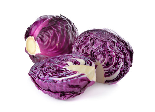 whole and cut fresh red cabbage on white background