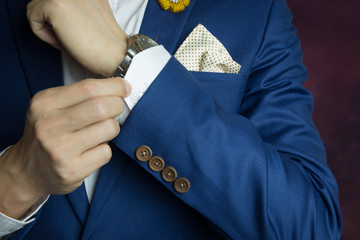man in blue suit, doing button