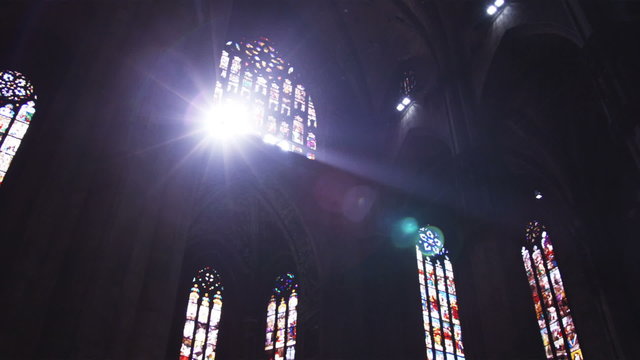 Sun shining through windows of a church in Milan Italy.