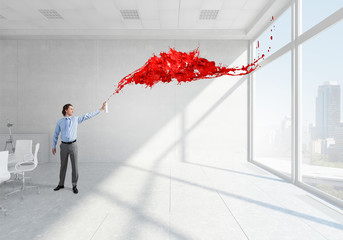 Businessman with aerosol can