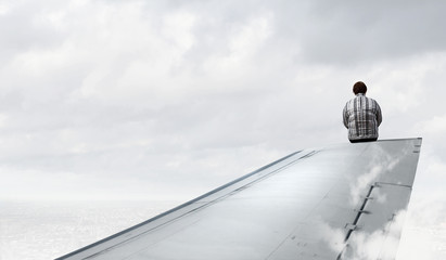 Obraz premium Woman on airplane wing