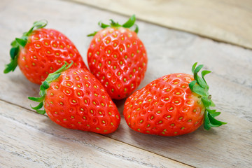 Fresh strawberries on wooden background