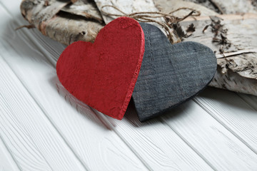 Wooden hearts on white wood background