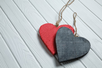 Wooden hearts on white wood background