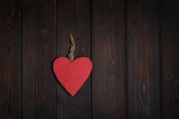 Wooden heart on dark wood background