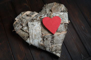Wooden hearts on dark wood background
