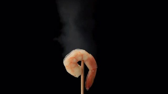 Hot shelled prawn steaming on the end of a skewer prores HQ