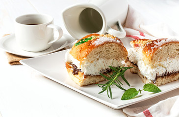 Cream cake with a cup of coffee and jar