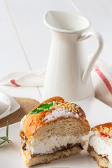 Cream cake with a cup of coffee and jar