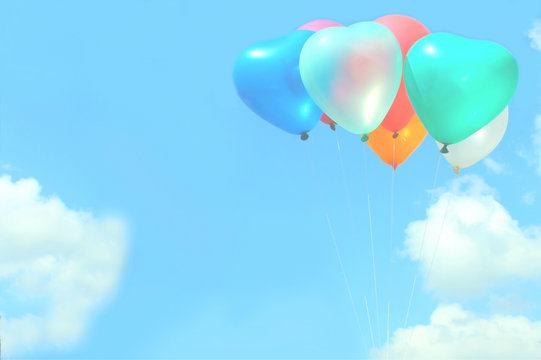 The soft focus colorful heart-shaped balloons with blue sky background in vintage style, concept of love in summer and valentine, wedding, selective focus with the white balloon in the front